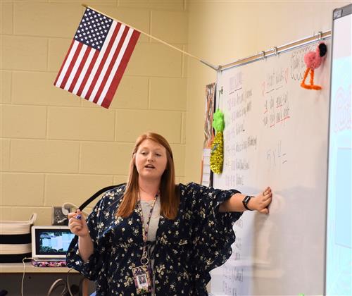 Teacher at whiteboard in front of class